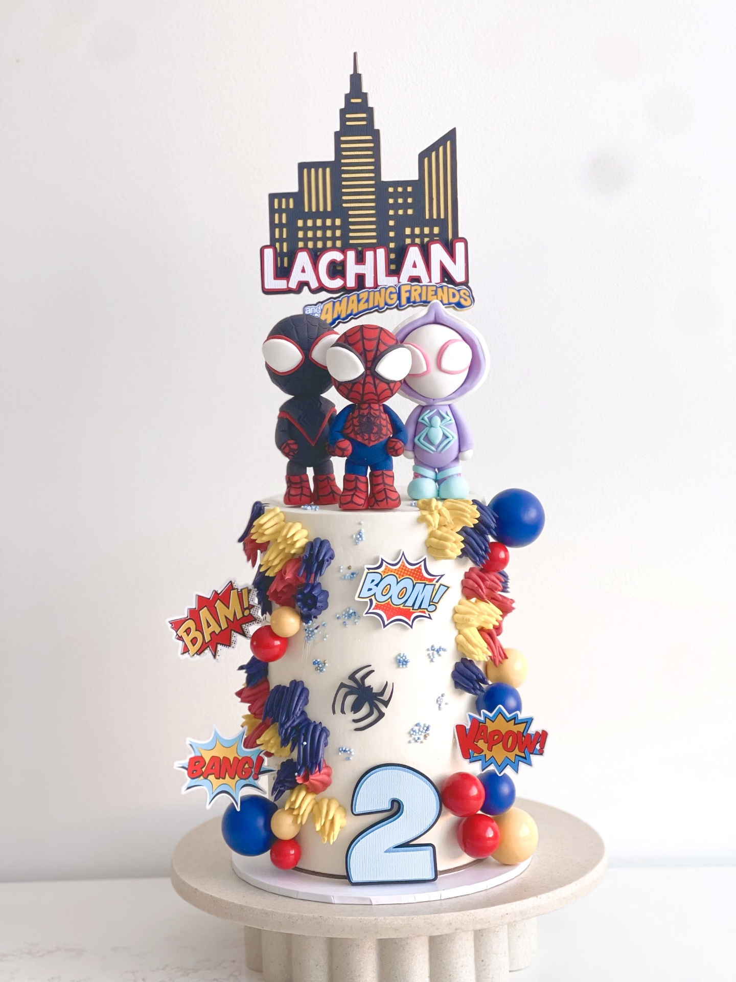 Spider-Man and Amazing Friends two-tier kids birthday cake with comic accents