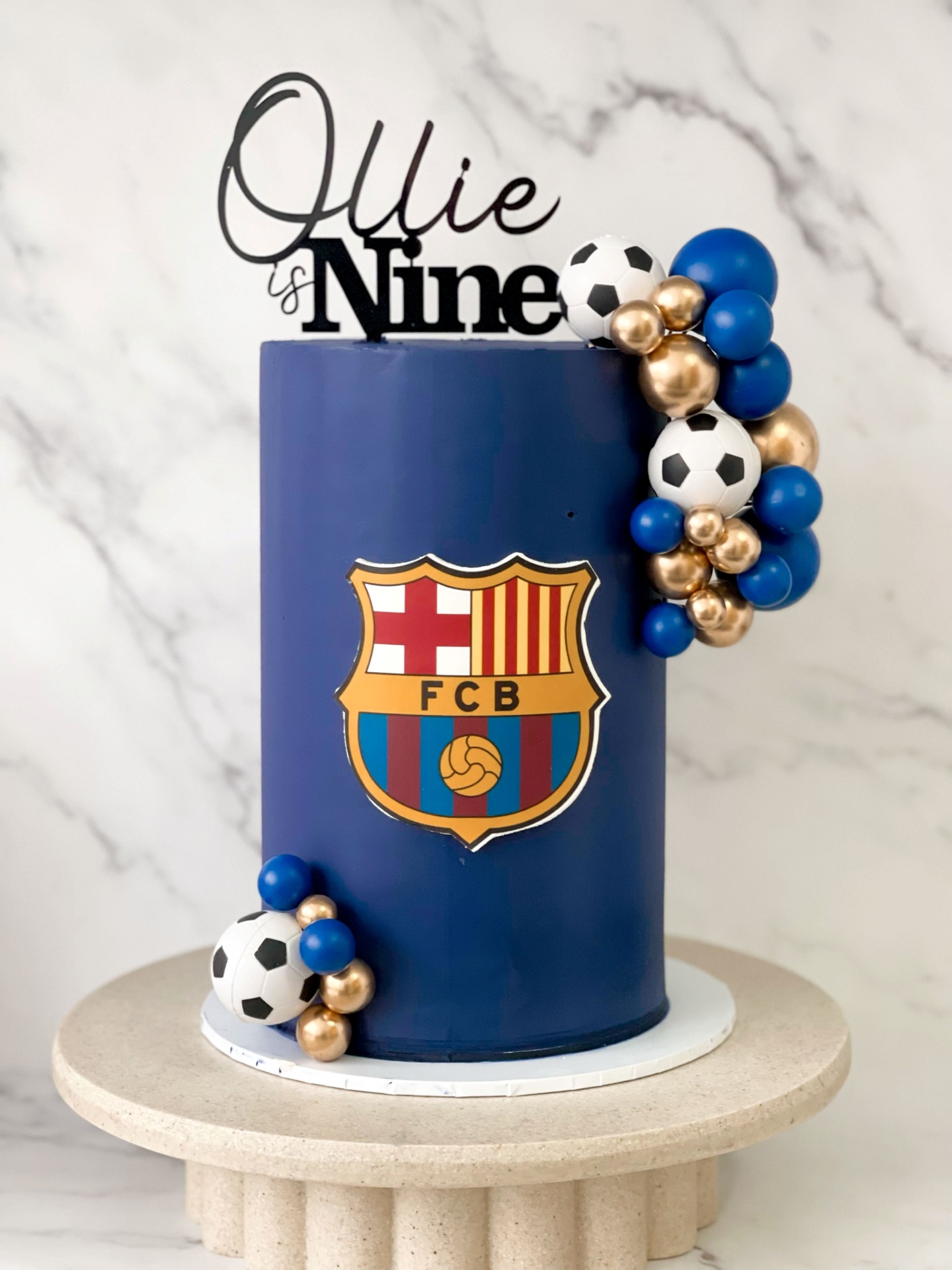 Navy FC Barcelona football cake with soccer ball and gold sphere arrangement