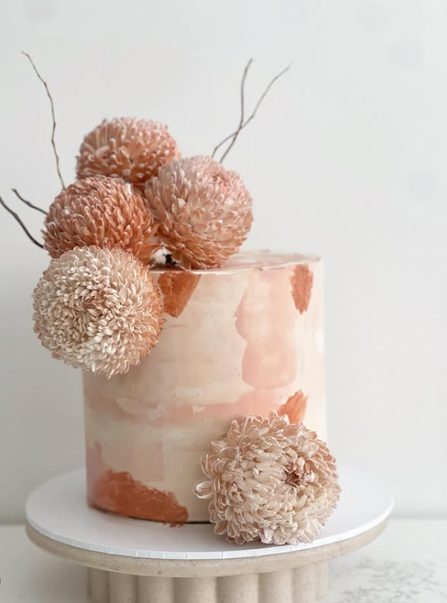 Blush watercolour buttercream celebration cake with dried floral pom-poms